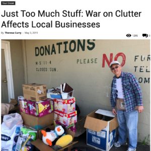 Man next to piles of donations